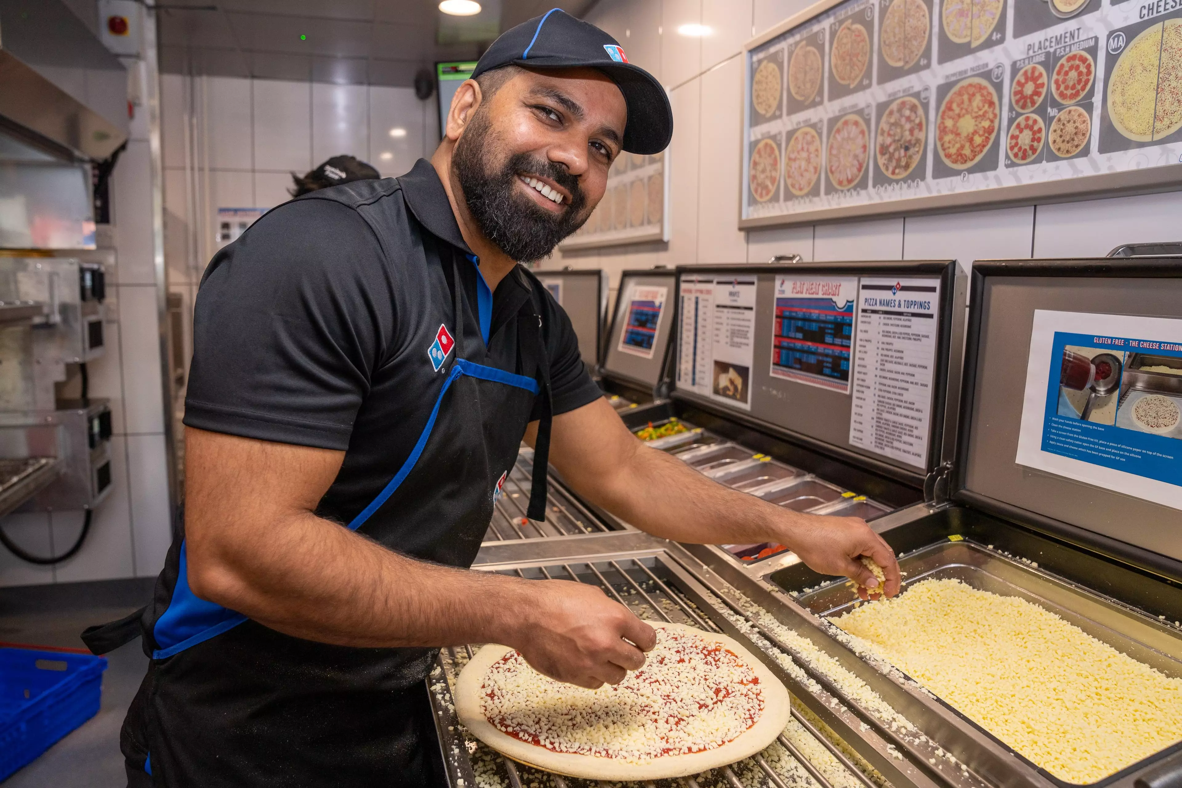 Pizza owner stood with employee