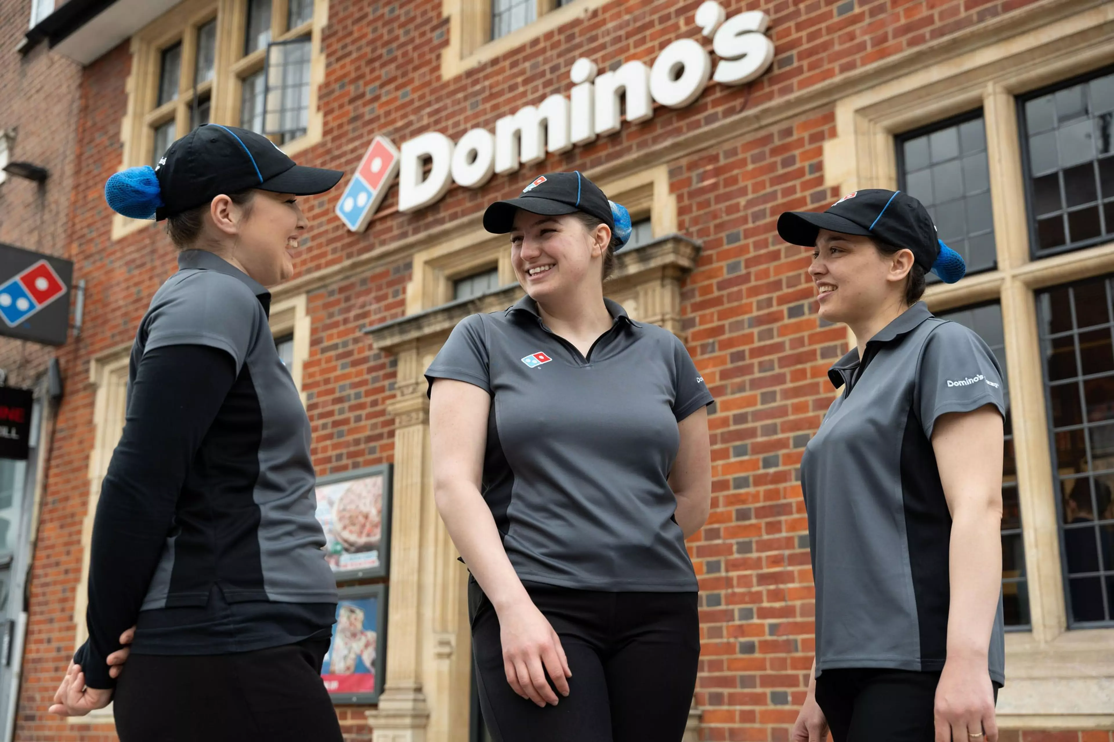 Dominos staff laughing outside store