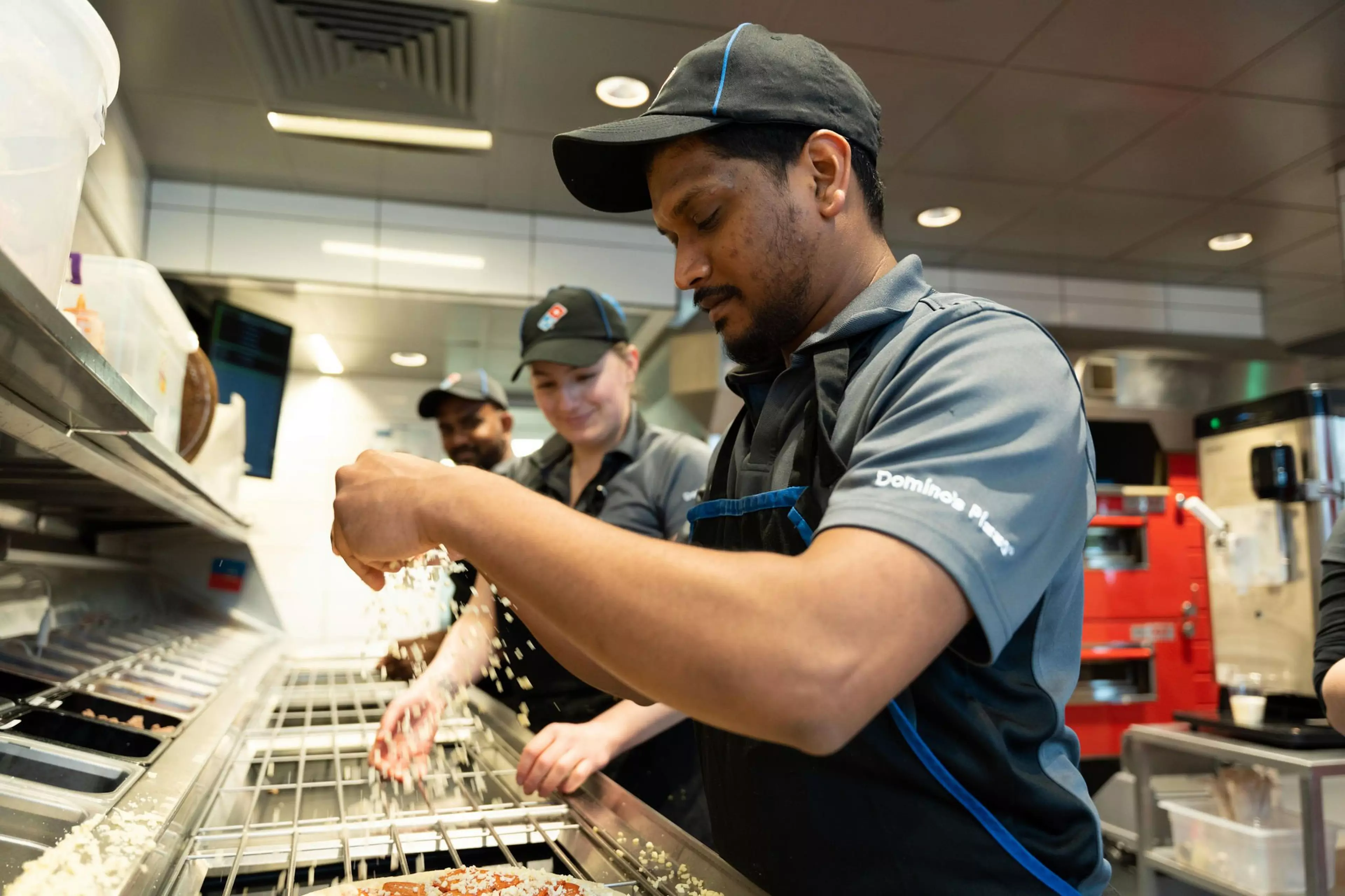 Dominos workers outside a store