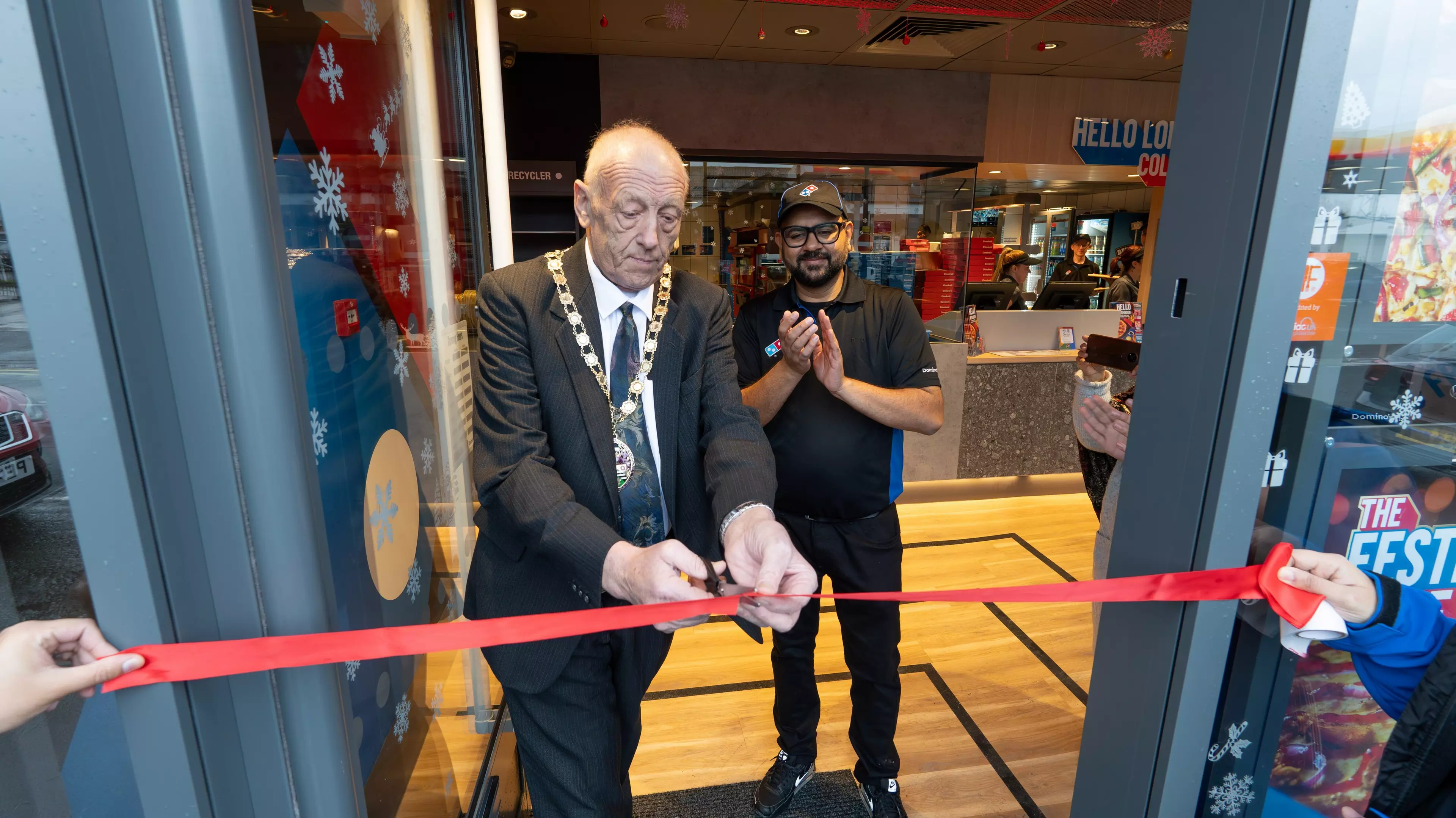 A domino's store team celebrating a donation of £7000 for the teenage cancer trust