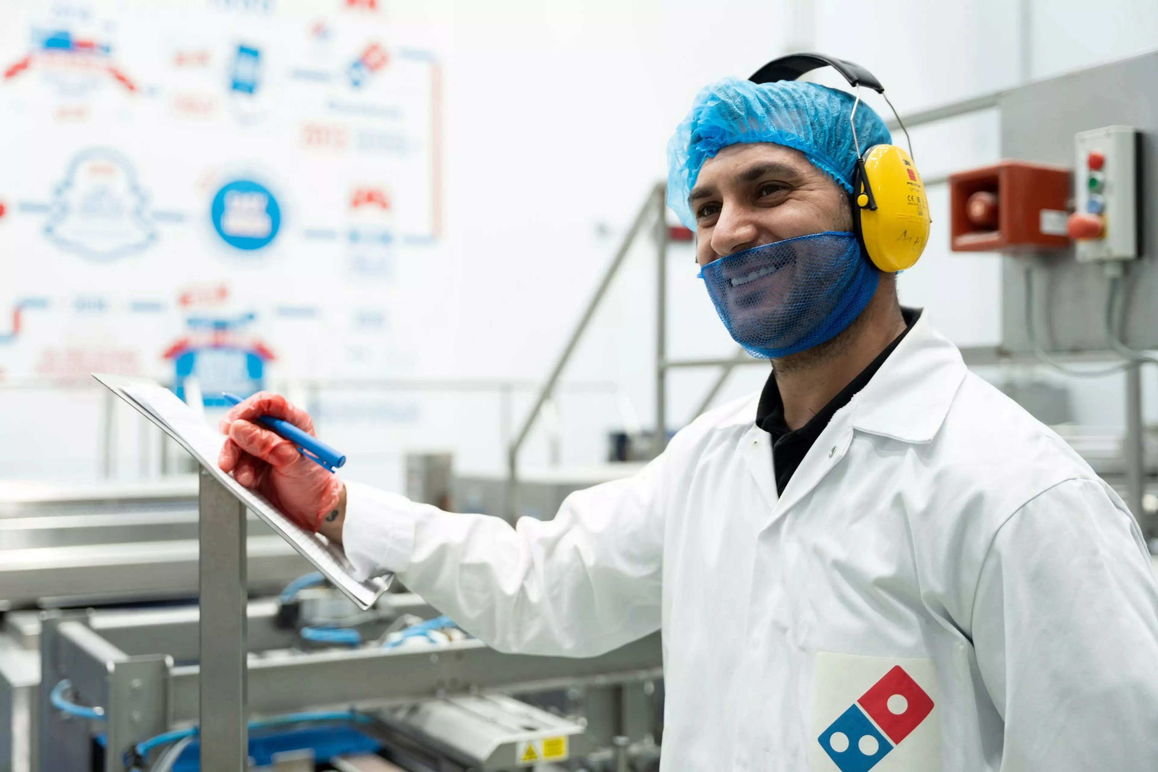 Man wearing PPE working in the supply chain centre