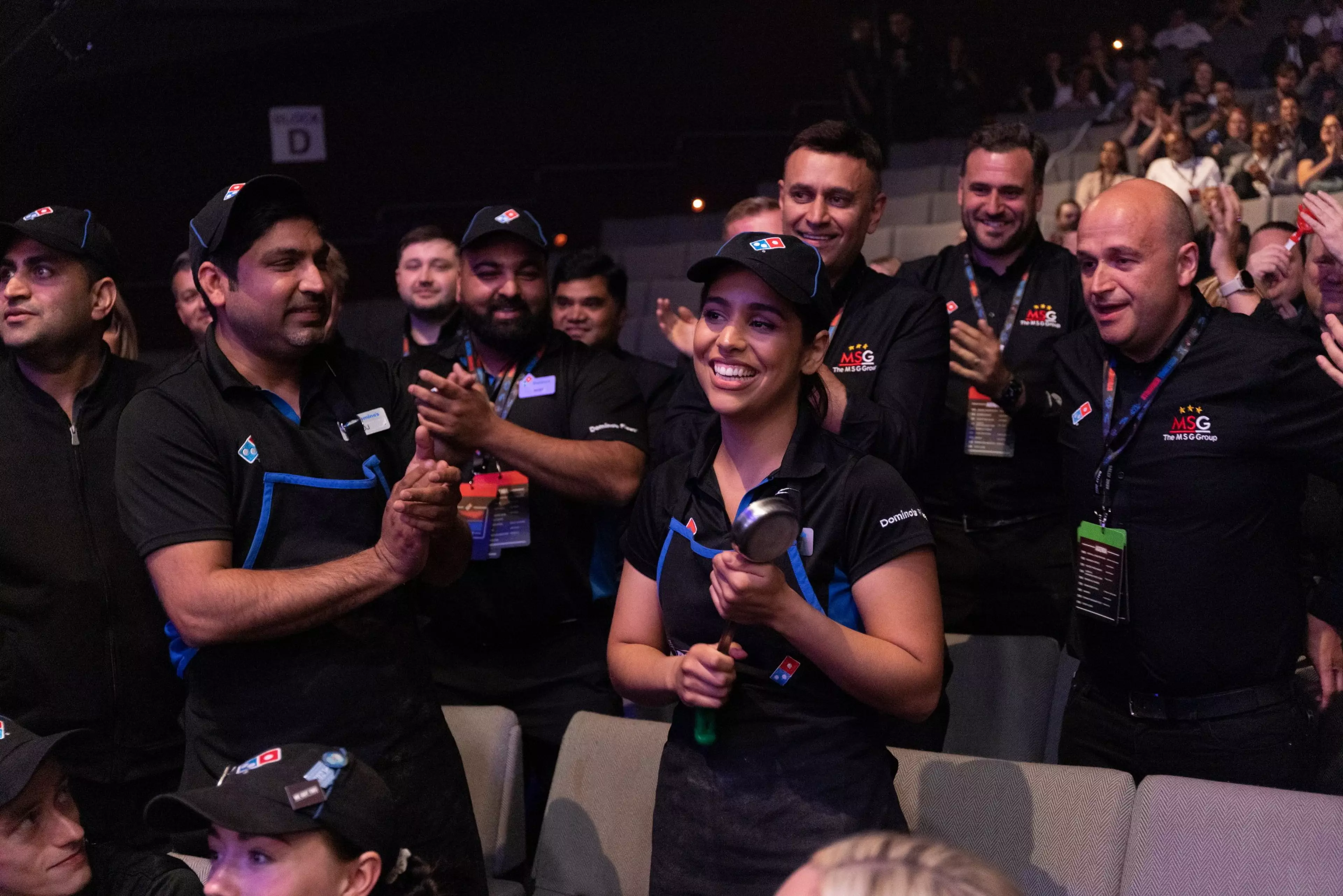 A group of domino's employees chanting