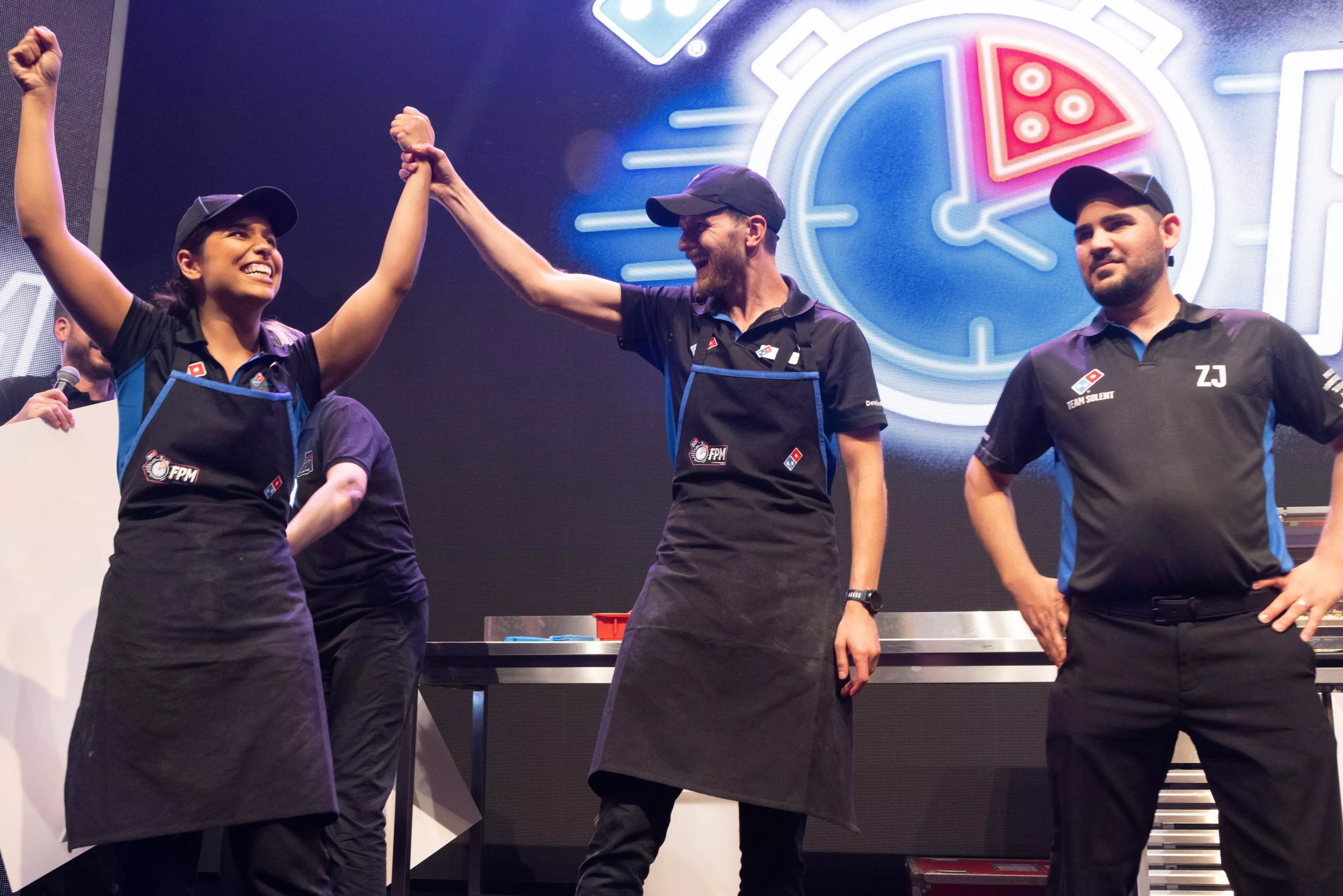 Three woman Domino's employees smiling together